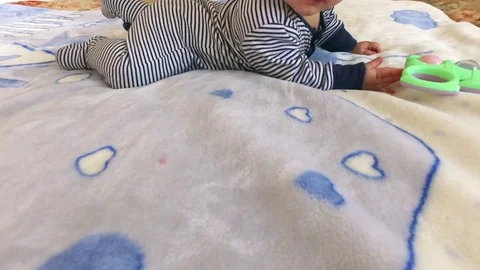 The kid plays with a rattle Stock Footage 81885837