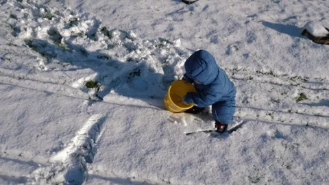 Kid Plays in Snow Stock Footage 300805101