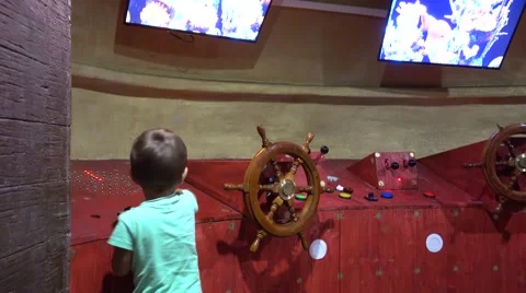 Kid plays in submarine wheelhouse Stock Footage