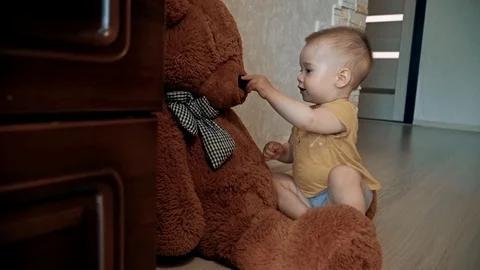 The kid plays with a teddy bear. Stock Footage 111725321