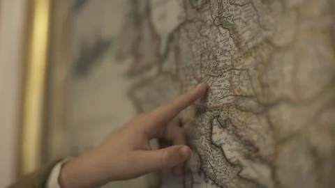 Kid points on a vintage old map with his finger Stock Footage 71337455