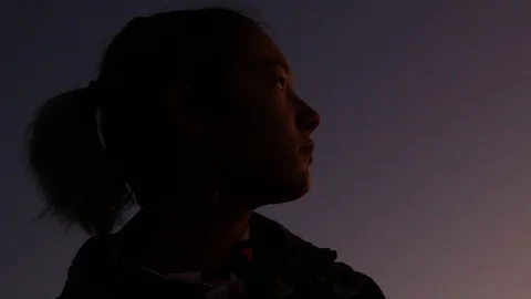 Kid with ponytail at dusk Stock Footage 123209596