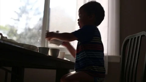 Kid pouring himself a cup of tea, video Video stock 79563086