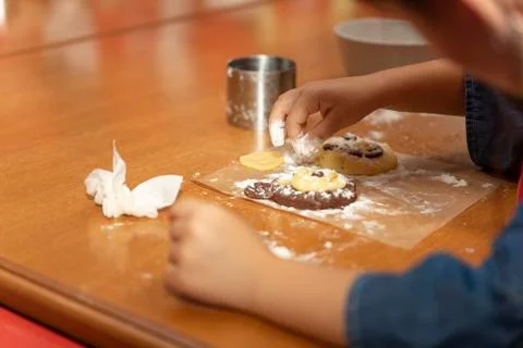 The kid prepares a cake in the shape of a bear at a cooking class for kids Foto stock
