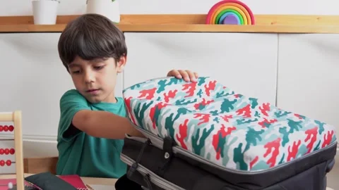 Kid preparing backpack in a  to go to school Stock Footage 279337773