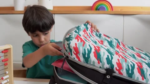 Kid preparing backpack in a  to go to school Stock Footage 279337825