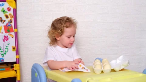 Kid preparing to decorate Easter eggs. Little caucasian boy playing with Stock-Footage 330109041