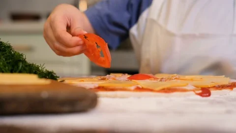Kid preparing pizza. Child spread the filling on the dough for pizza Stock Footage 125565979