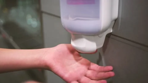 Kid pressing button of dipenser with sanitizer but its empty and not working Stock Footage 139194552