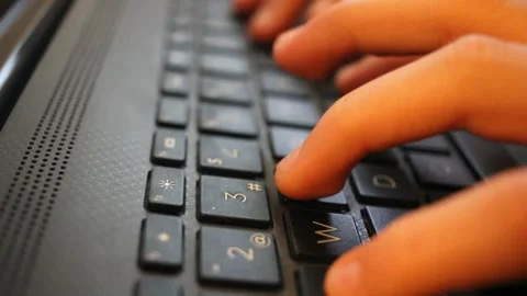 Kid pressing the keys of a laptop Stock Footage 324681765