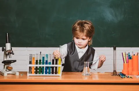 Kid from primary school. It was a little chemistry experiment. Happy little Stock Photos