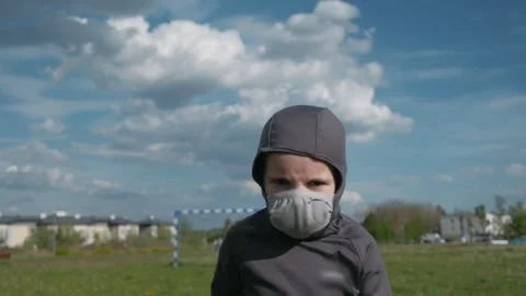 Kid with protective mask running on field. Active boy on nature. Slow motion Stock Footage 131097340