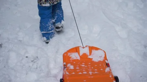 Kid Pulling Slider on Snow Stock-Footage 133965303