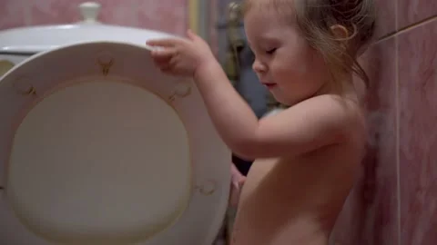 Kid put his hand open Toilet Lid, Close Up. White Bathroom Vídeos de archivo 153503441