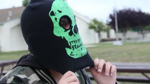 Kid puts on creepy mask Stock Footage 155490154