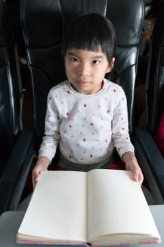 Kid reading book in a flight Stock Photos