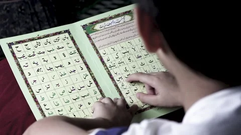 Kid reading islamic book Stock Footage 134291184