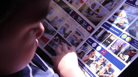 Kid reading in the plane safety instructions Stock Footage 973177