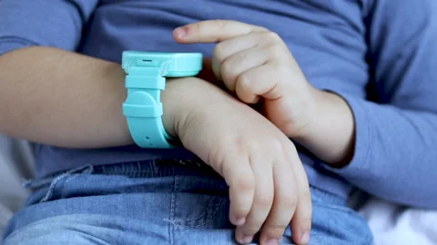 Kid receive smart watch in box as gift sitting on bed blanket 스톡 동영상 229295443