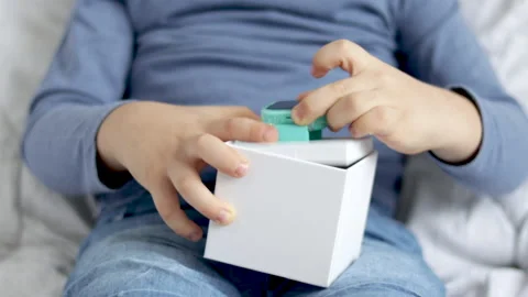 Kid receive smart watch in box as gift sitting on bed blanket 스톡 동영상 229295451