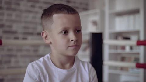 Kid in red boxing gloves training in his child room. Imagine to become the best Stock Footage 111546423
