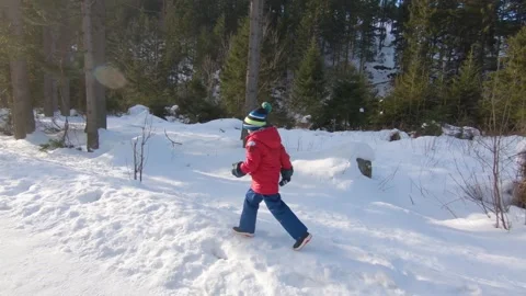Kid in red jacket runs in the valley between mountains of Zakopane, Poland. Stock Footage 152422978