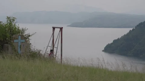 Kid ride on a Swing at Tarabunga Hill looking to Danau Toba, Indonesia Stock Footage 245243560