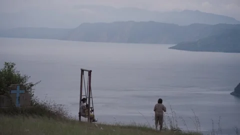 Kid ride on a Swing at Tarabunga Hill looking to Danau Toba, Indonesia Stock Footage 245244867