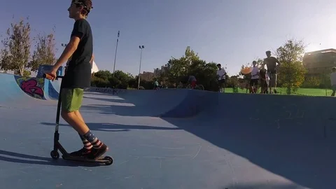 Kid Riding Kick Scooter In Skatepark Slow Motion Steadicam Stock Footage