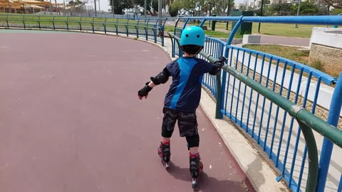 Kid on roller blades with protective gear Stock Footage 241415929