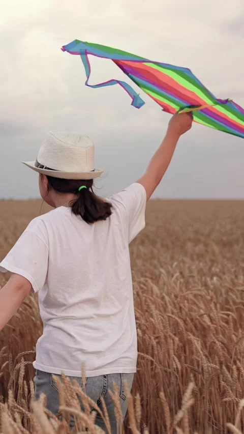 Kid run playing with kite in sky, carefree childhood. Child girl launching kite Stock Footage 302799143
