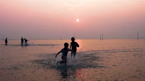 Kid running and playing at the ocean. Stock Footage 128026746