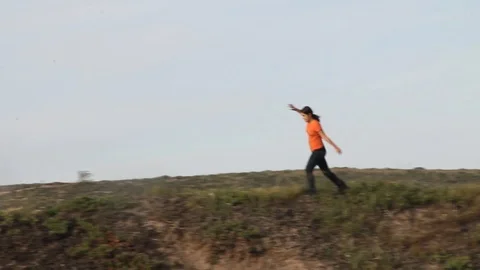 Kid running around on top of hill Stock Footage 113911059