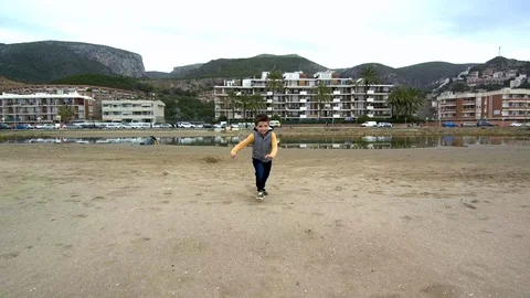 Kid Running To Camera on the beach. Aerial shoot Stock Footage 86696565