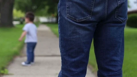 Kid running down the sidewalk from dad, video Видео 78534674