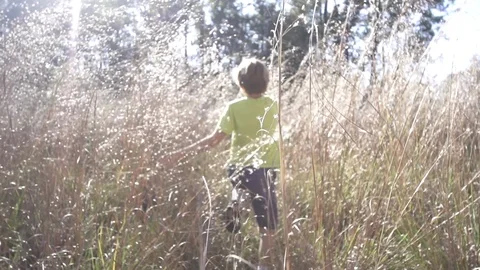 Kid running in grass Stock Footage 97899772