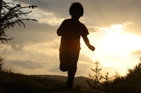 Kid running on meadow Stock Photos