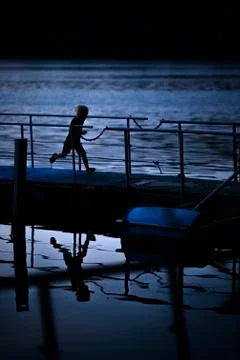 Kid running on the pier Stock Photos