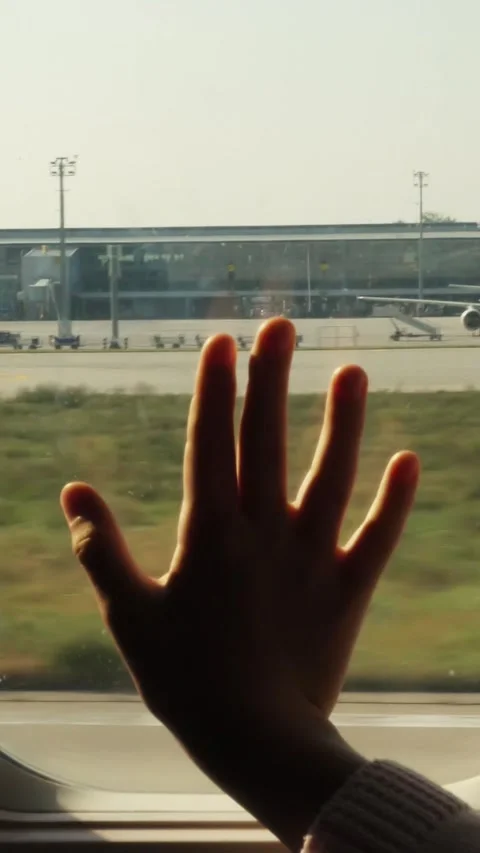Kid s hand touching airplane window, close up. Silhouette of a child's palm Stock Footage 316264210