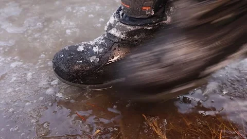 Kid ’s Waterproof Boot Stepping on Melting Ice in Early Spring Transition Stock Footage 306008033