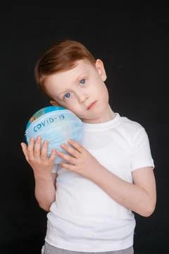 Kid in Self isolation looking at globe learning about Covid-19 Coronavirus from Stock Photos