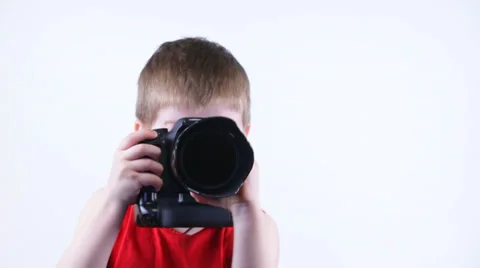 Kid shoots at the camera and smiling Stock Footage 37204130