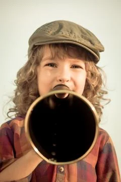 Kid shouting through megaphone Stock Photos
