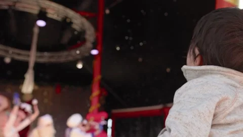 Kid at the show looks at the soap bubbles Stock Footage 244828414