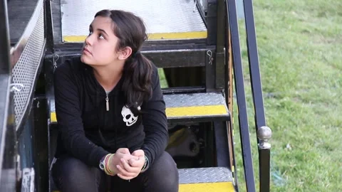 Kid sits on steps of empty ride 動画素材 154938913