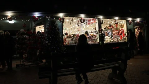 Kid sitting alone on bench in town on Christmas Stock Footage 122055458