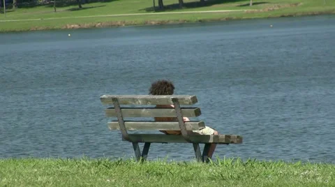 Kid Sitting On Bench At Lake Stock Footage 1218517