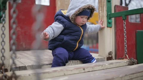 The kid is sitting on a hill Stock Footage 116771436