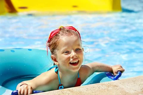 Kid sitting on inflatable ring. Stock Photos