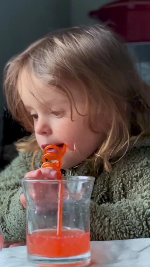 Kid Sitting at Table Drinking Juice from Glass 스톡 동영상 333149602